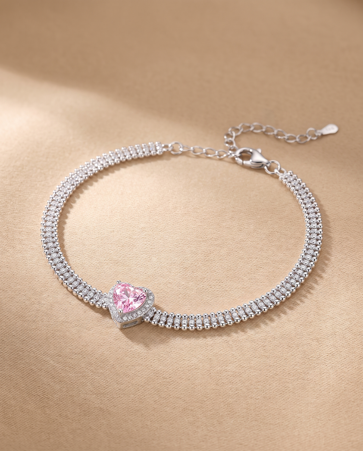 Pink Heart Triple Chain Bracelet in 925 sterling silver on a beige linen surface